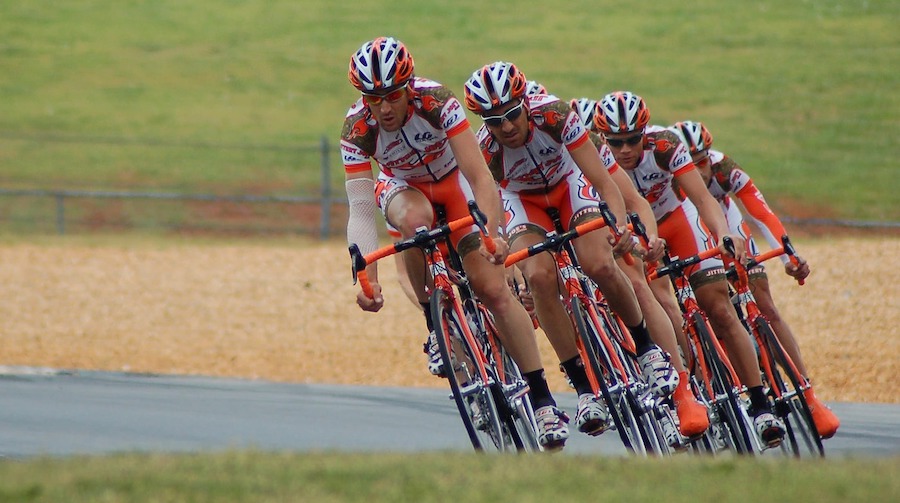 A team of race cyclists working together in perfect harmony
